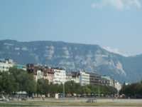 Semi-distant mountains looming over multi-story buildings