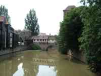 River with combination bridge and buildings over it