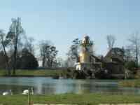 Tower behind pond with swans