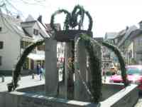 Crown-shaped fountain decorated with greenery and Easter eggs