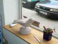 Small white stone sparrow sculpture