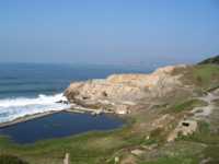 Cliffs and hills and buildings by a beach