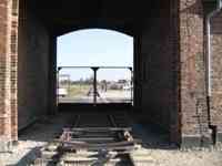 Railroad tracks in a short tunnel through a building