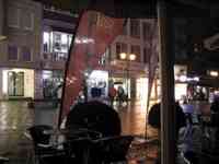 Shopping district in light rain at night viewed from cafe table