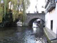 Blau flowing under a footbridge