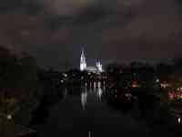 Long view of Münster behind Danube illuminated at night