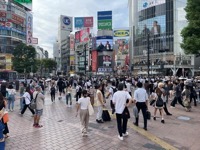 Many pedestrians crossing at large intersection